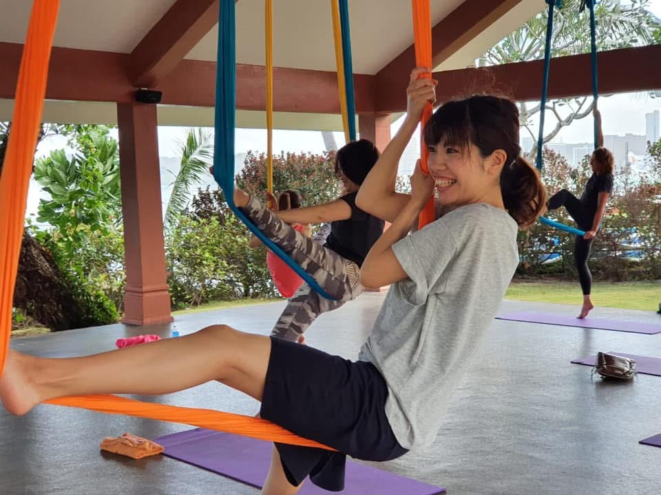 Student in an orange silk swing